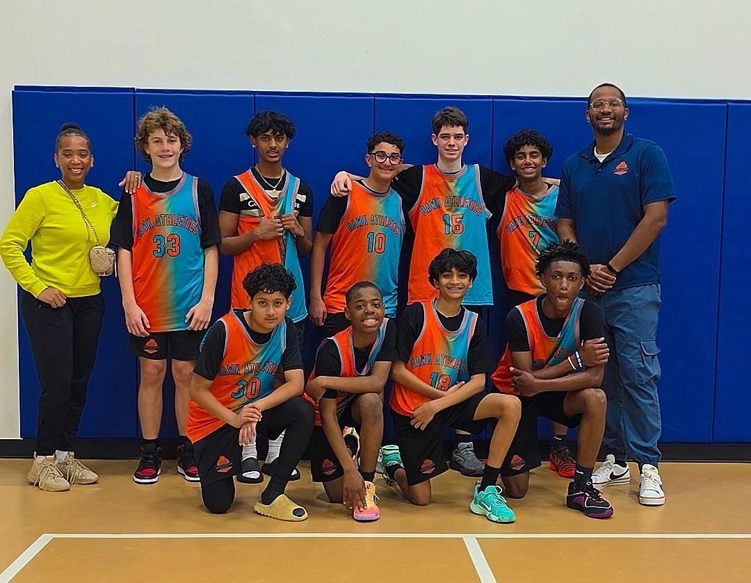 Hawk Athletics Academy team in teal and orange jerseys with their coaches